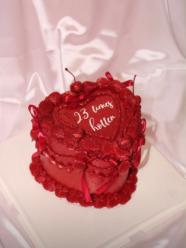 A red heart cake piped with 23 times hotter