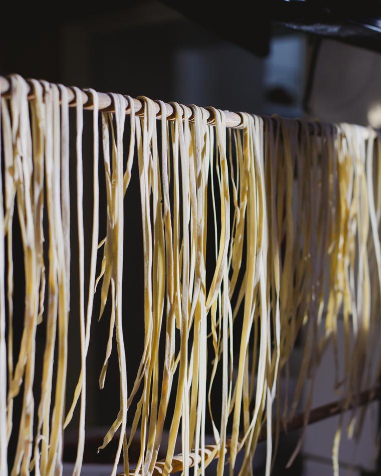 Lengths of fresh pasta hung to dry