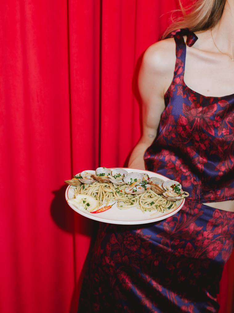 A plate of pasta against the red curtain