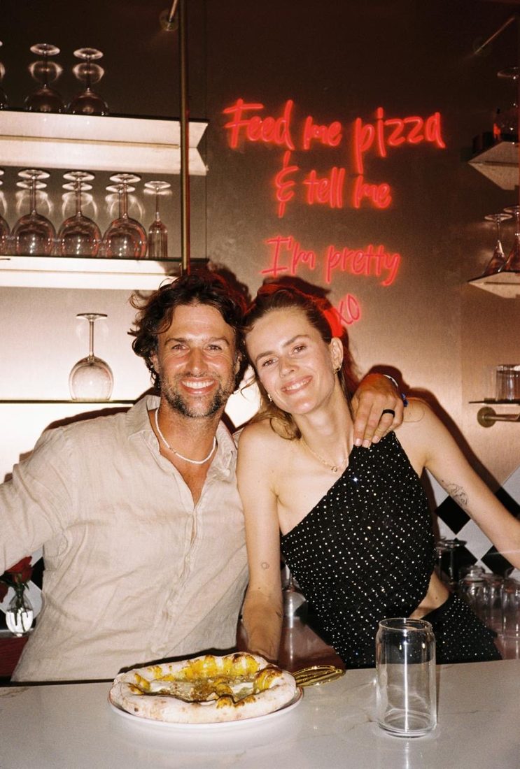 A couple at the bar under the neon