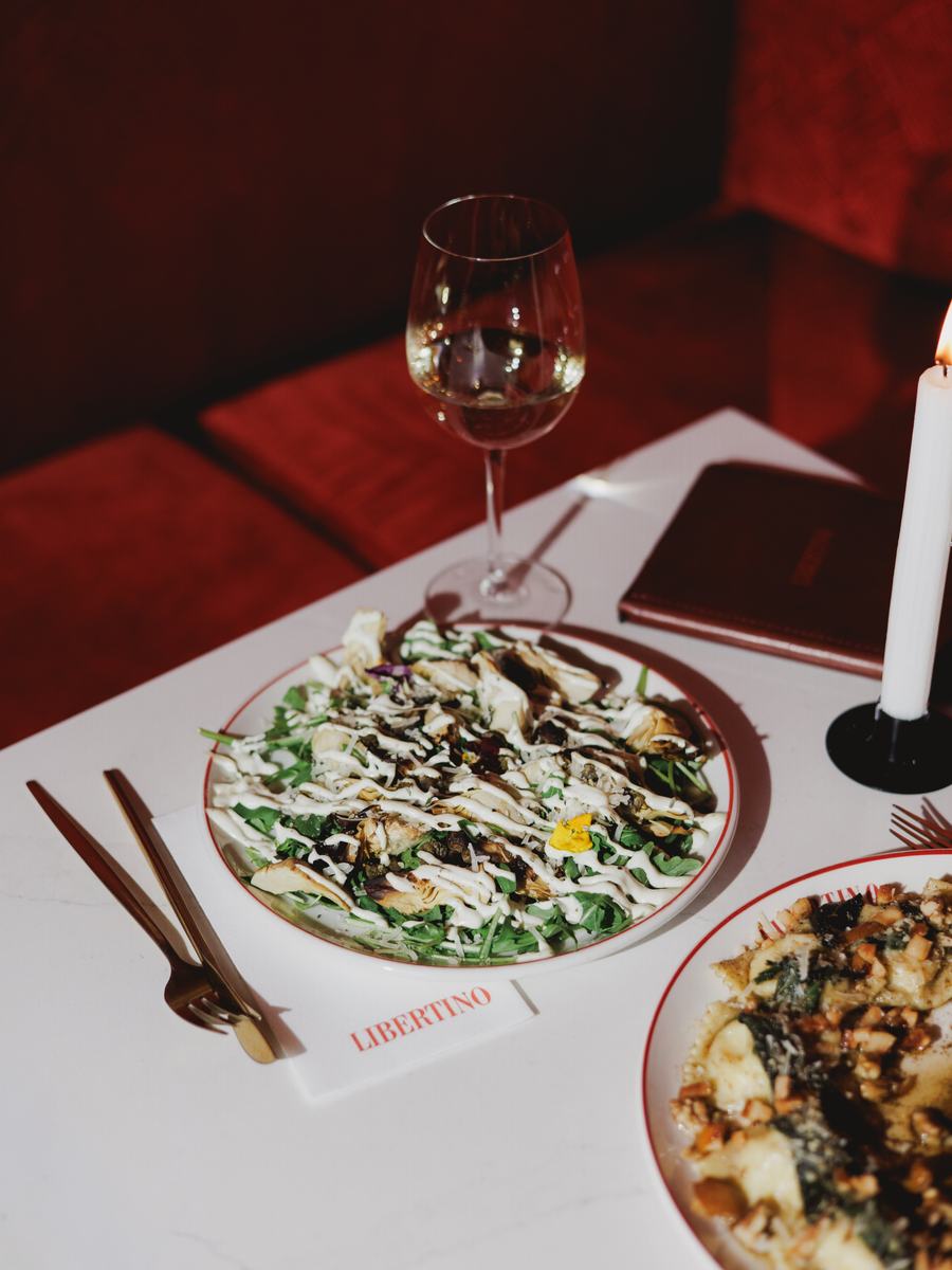 A table set with a candle and a glass of wine