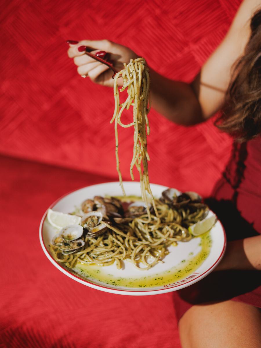A forkful of spaghetti lifted above the plate